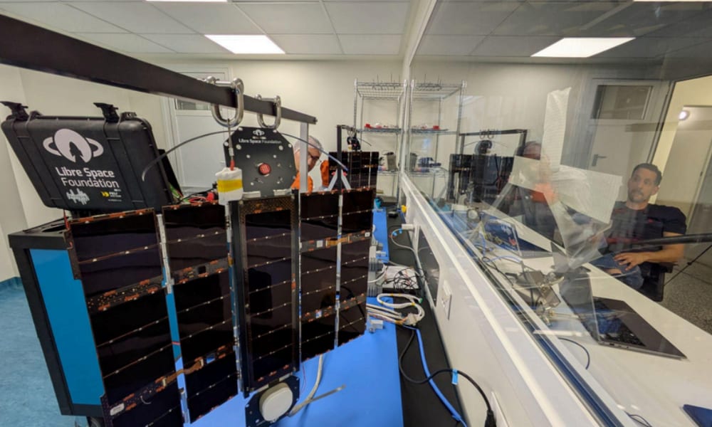 LSF cleanroom — PHASMA flight units hanging on the integration rig, operators working through the antechamber window